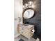 Stylish powder room featuring a floating vanity, vessel sink, modern lighting, and accent wall at 5910 W Sumac Ave, Littleton, CO 80123