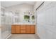 Bright bathroom featuring a double sink vanity, glass shower and plenty of storage space at 5910 W Sumac Ave, Littleton, CO 80123