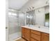 Bright bathroom featuring a single sink vanity and walk-in glass shower at 5910 W Sumac Ave, Littleton, CO 80123