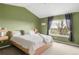 Bedroom with vaulted ceilings, gray curtains, and a large window with beautiful views at 5910 W Sumac Ave, Littleton, CO 80123