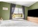 Bedroom with vaulted ceilings, gray curtains, and a large window with neighborhood views at 5910 W Sumac Ave, Littleton, CO 80123