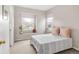 Cozy bedroom with light walls, large windows and a decorative plant and light filtering shades at 5910 W Sumac Ave, Littleton, CO 80123