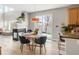 Cozy dining area with fireplace, round table and chairs, and a view of the backyard at 5910 W Sumac Ave, Littleton, CO 80123