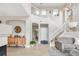 Spacious foyer with high ceilings, a staircase, hardwood floors, and stylish decor, creating a grand entrance at 5910 W Sumac Ave, Littleton, CO 80123