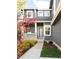 Inviting front entrance with a covered porch, stone accents, lush landscaping, and a charming walkway at 5910 W Sumac Ave, Littleton, CO 80123
