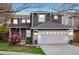 Charming two-story gray home featuring stone accents, a white garage door, and a beautifully landscaped front yard at 5910 W Sumac Ave, Littleton, CO 80123