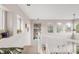 A sunny, carpeted hallway with large windows, views of trees, and white railings at 5910 W Sumac Ave, Littleton, CO 80123