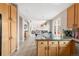 Bright, open kitchen features wood cabinets, granite countertops, and an expansive view into the living space at 5910 W Sumac Ave, Littleton, CO 80123