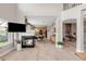 Open-concept living area with a fireplace, TV, and views of the adjacent dining and office spaces at 5910 W Sumac Ave, Littleton, CO 80123