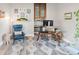 Bright office space features a glass desk, comfortable blue chair, and stylish patterned rug at 5910 W Sumac Ave, Littleton, CO 80123