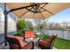 Inviting patio area with comfortable seating, a fire pit, and a large umbrella for shade, perfect for relaxing at 5910 W Sumac Ave, Littleton, CO 80123