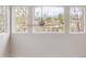 Large window view of the neighborhood with trees and street from an elevated vantage point at 5910 W Sumac Ave, Littleton, CO 80123
