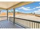 Covered back porch providing a view of a large backyard with wood fencing at 4371 Soapberry Pl, Castle Rock, CO 80108