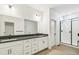 Modern bathroom with double sink vanity, stone countertop and glass shower at 4371 Soapberry Pl, Castle Rock, CO 80108