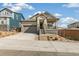 Charming front exterior of a home with a cozy porch, stone accents, and a two-car garage at 4371 Soapberry Pl, Castle Rock, CO 80108