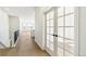 Bright hallway features wood floors, stairway, and double glass doors at 4371 Soapberry Pl, Castle Rock, CO 80108
