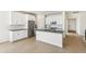 Modern kitchen featuring white cabinets, stainless steel appliances, an island, and stylish countertops at 4371 Soapberry Pl, Castle Rock, CO 80108
