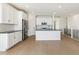 A well-lit kitchen is equipped with white cabinets, stainless steel appliances, and a central island with a breakfast bar at 4371 Soapberry Pl, Castle Rock, CO 80108