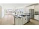 The kitchen showcases an island, stainless appliances, white cabinetry, and is integrated with a living area at 4371 Soapberry Pl, Castle Rock, CO 80108