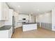 The open kitchen has white cabinets, stainless steel appliances, a central island, and seamless access to living spaces at 4371 Soapberry Pl, Castle Rock, CO 80108