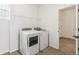 Laundry room features washer, dryer, and wire rack shelving at 4371 Soapberry Pl, Castle Rock, CO 80108