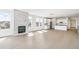 Bright open-concept living area featuring sleek hardwood floors, a modern fireplace, and a kitchen island at 4371 Soapberry Pl, Castle Rock, CO 80108
