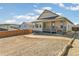 Rear exterior of a tan home with a porch and a large, unfinished backyard at 4371 Soapberry Pl, Castle Rock, CO 80108
