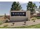Terrain community sign featuring manicured landscaping and stone details in Castle Rock, Colorado at 4371 Soapberry Pl, Castle Rock, CO 80108