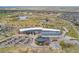 Aerial view of recreation center with lake, parking, and sport fields in a community with many homes at 15842 E Warner Dr, Denver, CO 80239