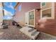 Small backyard with gravel and access to sliding door at 15842 E Warner Dr, Denver, CO 80239