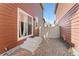 Small backyard with gravel and access to sliding door at 15842 E Warner Dr, Denver, CO 80239