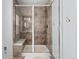 Modern bathroom with walk-in shower and built-in seat at 15842 E Warner Dr, Denver, CO 80239