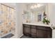 Clean bathroom with dark vanity and shower/tub combo at 15842 E Warner Dr, Denver, CO 80239