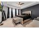 Spacious main bedroom with ceiling fan, large bed, and bench at 15842 E Warner Dr, Denver, CO 80239