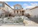 Two-story house with brown and beige siding, front yard, and walkway at 15842 E Warner Dr, Denver, CO 80239