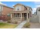 Charming two-story home featuring a cozy front porch and well-maintained landscaping at 15842 E Warner Dr, Denver, CO 80239