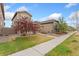 Beautiful home with a well-kept lawn, landscaping, and a sidewalk leading to the front at 15842 E Warner Dr, Denver, CO 80239