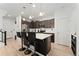 Modern kitchen with island, dark cabinets, and stainless steel appliances at 15842 E Warner Dr, Denver, CO 80239