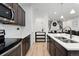 Modern kitchen with stainless steel appliances and an island at 15842 E Warner Dr, Denver, CO 80239