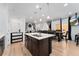 Bright kitchen with an island, stainless steel appliances, and dark cabinets at 15842 E Warner Dr, Denver, CO 80239