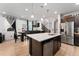 Open concept kitchen features an island and stainless steel appliances at 15842 E Warner Dr, Denver, CO 80239