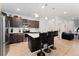Modern kitchen with island, stainless steel appliances, and dark cabinetry at 15842 E Warner Dr, Denver, CO 80239