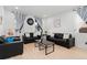 Living room with two black sofas, coffee table, and hardwood floors at 15842 E Warner Dr, Denver, CO 80239