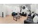 Living room with two black sofas, coffee table, and hardwood floors at 15842 E Warner Dr, Denver, CO 80239