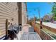 Backyard patio area includes a grill, a dining table, privacy fence, and string lights at 4316 S Netherland St, Aurora, CO 80015