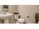 Charming half bath features pedestal sink and tasteful decor at 4316 S Netherland St, Aurora, CO 80015