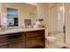 This renovated bathroom has white subway tile, granite counters and brown cabinets at 4316 S Netherland St, Aurora, CO 80015