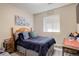 Comfortable bedroom with a queen-size bed, soft bedding, stylish decor, and a window with natural light at 4316 S Netherland St, Aurora, CO 80015