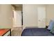Bedroom features a queen bed, open doorway, built-in mirror, and a wall-mounted door at 4316 S Netherland St, Aurora, CO 80015