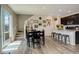 Open dining area with easy access to the kitchen, stairs, and outdoor patio at 4316 S Netherland St, Aurora, CO 80015